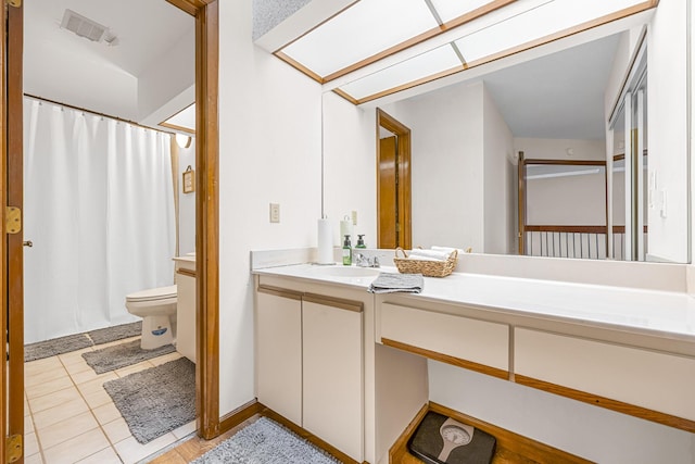 bathroom featuring visible vents, a shower with shower curtain, toilet, vanity, and tile patterned flooring