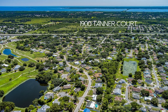 bird's eye view featuring a water view and a residential view