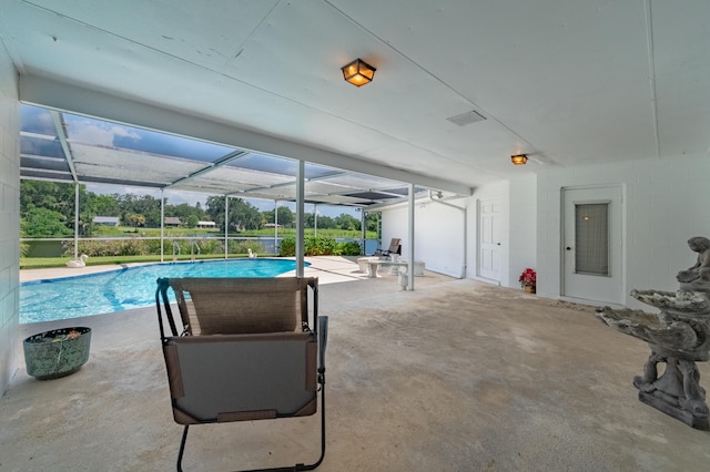 outdoor pool with a lanai and a patio area