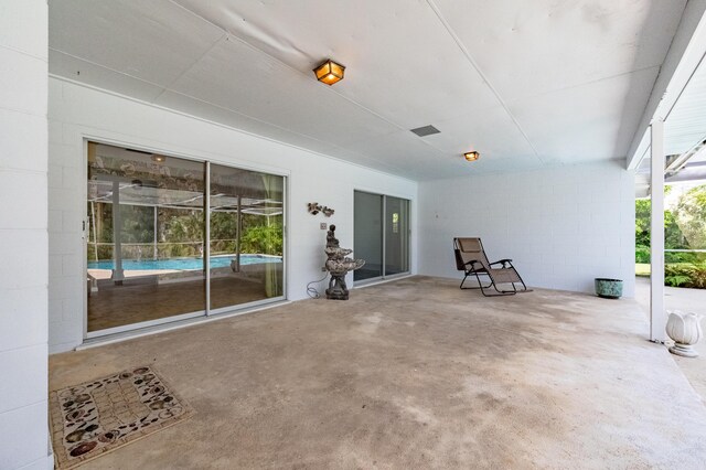 view of patio featuring a lanai