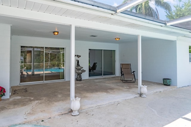 view of patio / terrace featuring glass enclosure