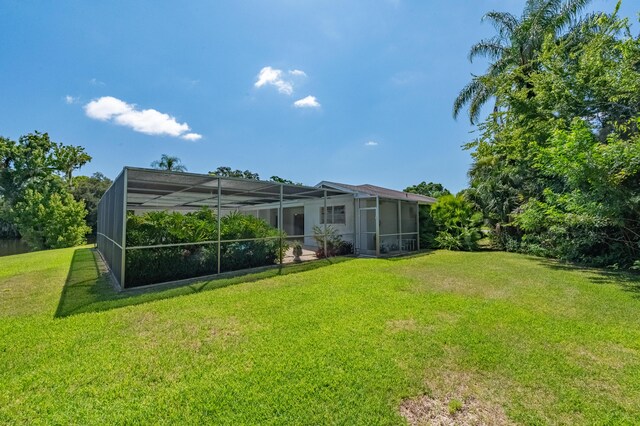 view of yard featuring glass enclosure