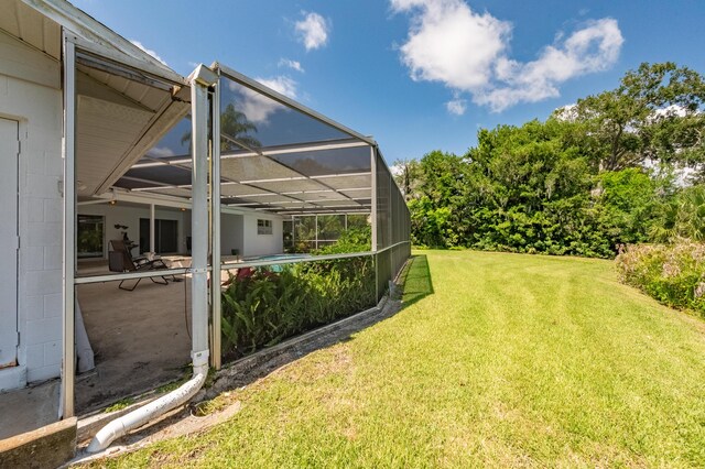 view of yard with glass enclosure