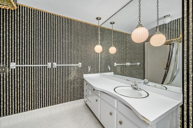 bathroom featuring tile patterned flooring, vanity, and wallpapered walls