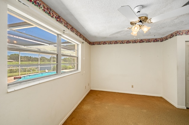 unfurnished room featuring a textured ceiling and ceiling fan