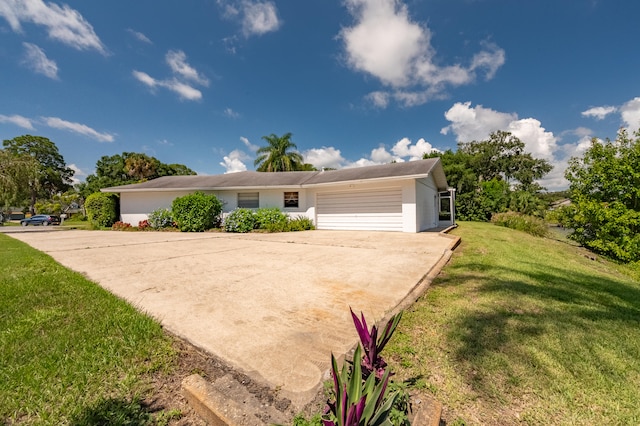 ranch-style house with a garage and a front yard