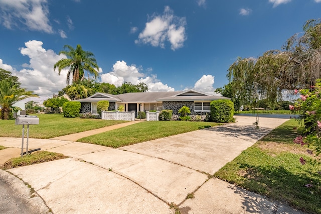 ranch-style home featuring a front lawn