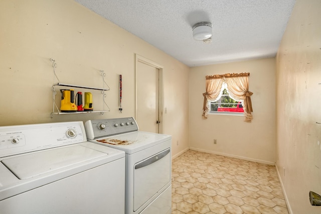 laundry area featuring laundry area, independent washer and dryer, a textured ceiling, and baseboards