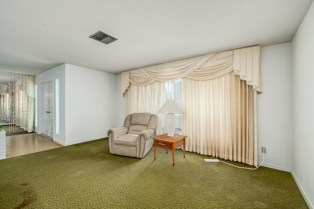 unfurnished room featuring carpet and a textured ceiling