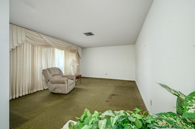 unfurnished room featuring visible vents, baseboards, and carpet