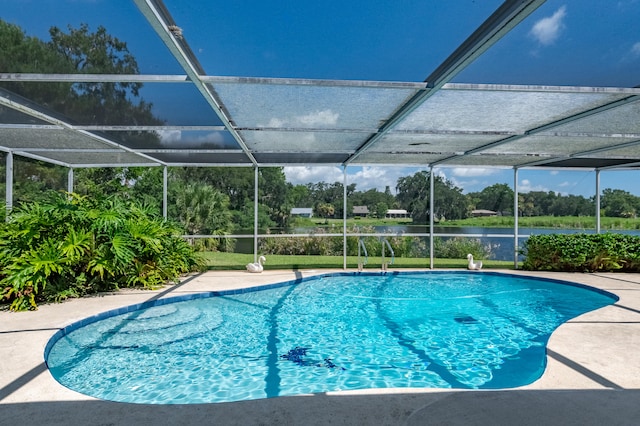 view of swimming pool featuring glass enclosure