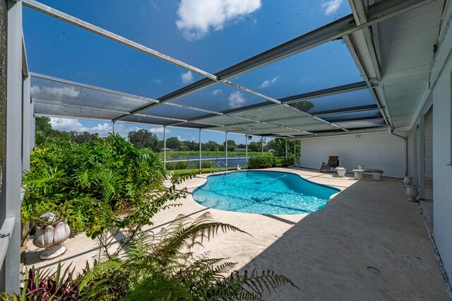 view of pool featuring a patio and glass enclosure