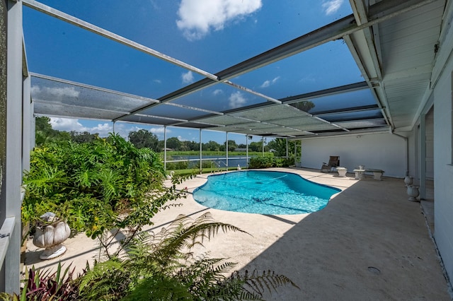 outdoor pool featuring glass enclosure and a patio area