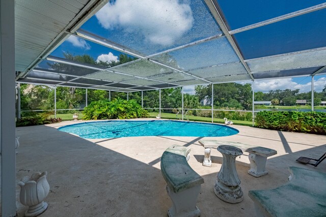 view of swimming pool with a patio and a lanai