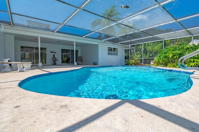 outdoor pool with a lanai and a patio area