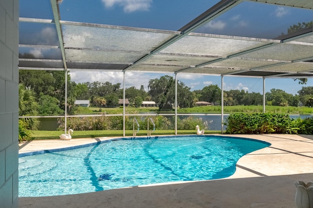 pool featuring glass enclosure and a patio area