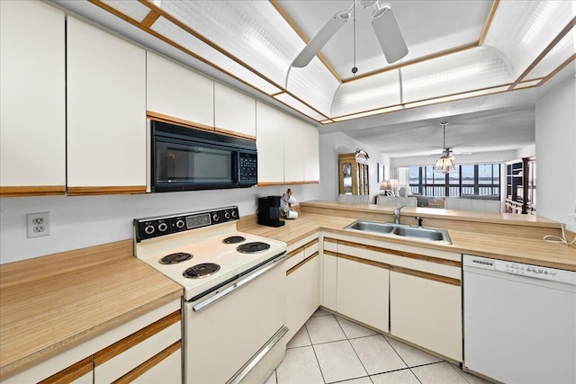 kitchen with ceiling fan with notable chandelier, white appliances, sink, and white cabinets