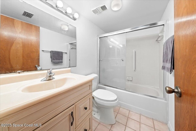 250 S Sykes Creek Pkwy Unit 309, Merritt Island, FL 32952 - bathroom featuring tile patterned floors, vanity, toilet, and enclosed tub / shower combo