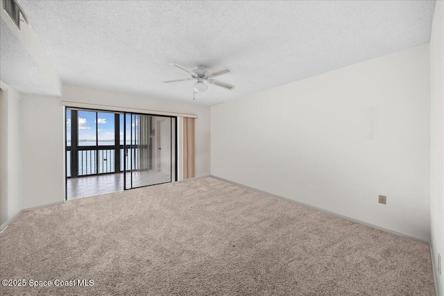 250 S Sykes Creek Pkwy Unit 309, Merritt Island, FL 32952 - carpeted spare room with ceiling fan, a textured ceiling, and baseboards
