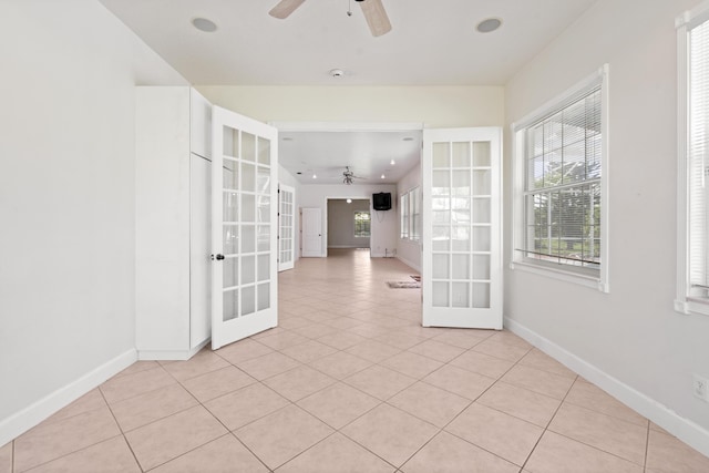 spare room featuring ceiling fan, light tile patterned flooring, and french doors