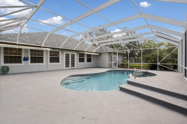 view of swimming pool featuring french doors, a patio, and a lanai