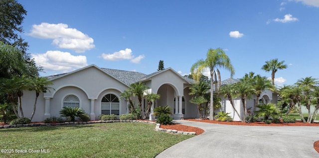 mediterranean / spanish house with a front lawn