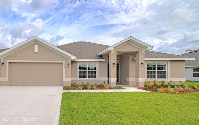 view of front of property featuring a front lawn and a garage