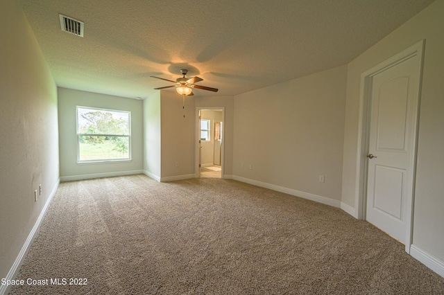 interior space with ceiling fan and a textured ceiling