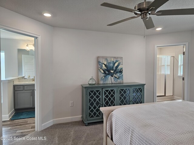 920 Lyons Cir NW, Palm Bay, FL 32907 - bedroom with baseboards, recessed lighting, ensuite bath, a textured ceiling, and a ceiling fan