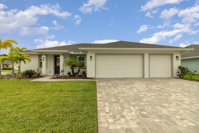 view of front of property with a garage and a front lawn