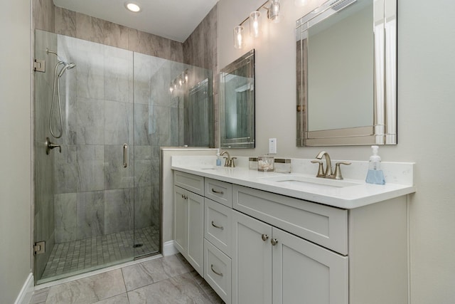 bathroom featuring vanity and a shower with door