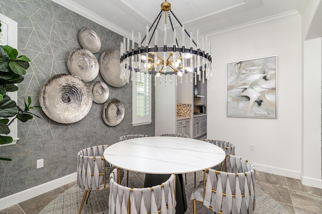 dining area with ornamental molding and a notable chandelier