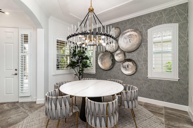 dining space with baseboards, ornamental molding, arched walkways, and a wealth of natural light