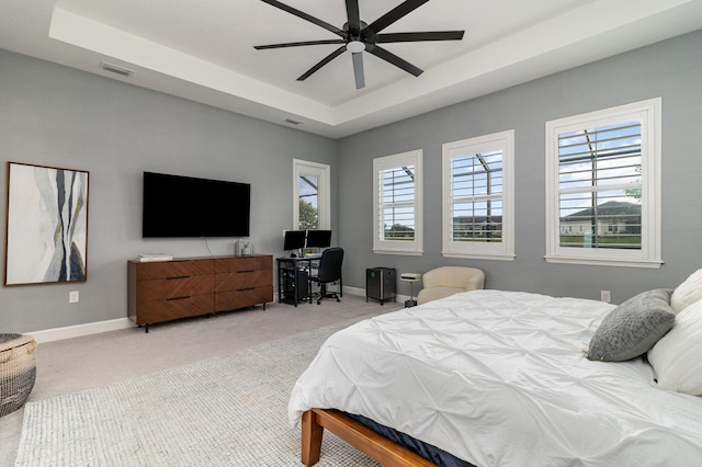 bedroom featuring carpet, a raised ceiling, visible vents, and baseboards