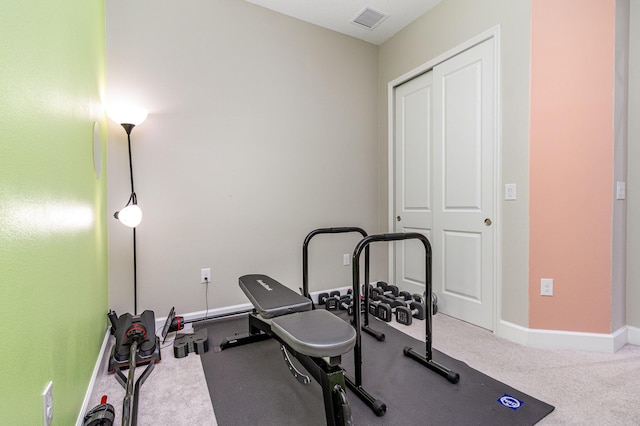 workout room with carpet floors, baseboards, and visible vents