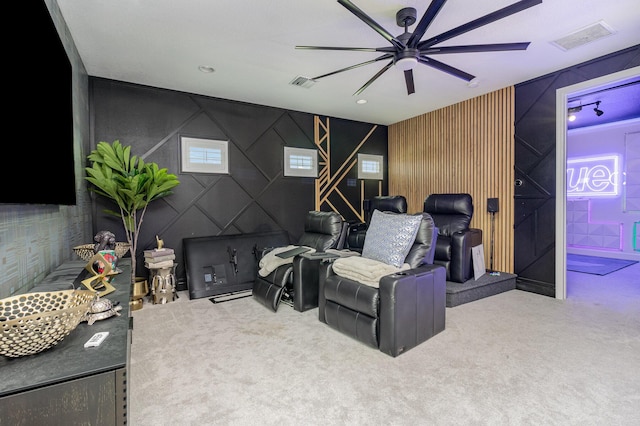 carpeted home theater room with ceiling fan