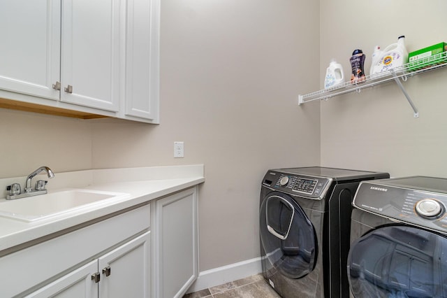 clothes washing area with separate washer and dryer, sink, light tile patterned floors, and cabinets