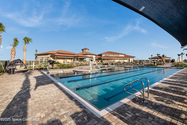 community pool with a patio area and a gazebo