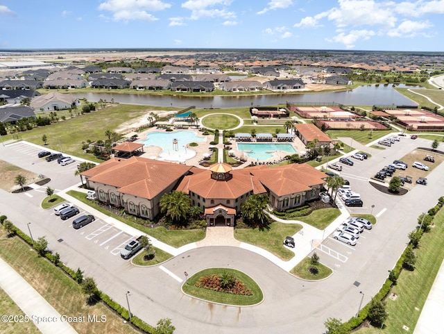 birds eye view of property with a water view and a residential view