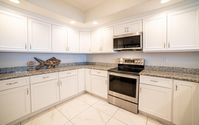 kitchen with white cabinets, stainless steel appliances, and stone counters