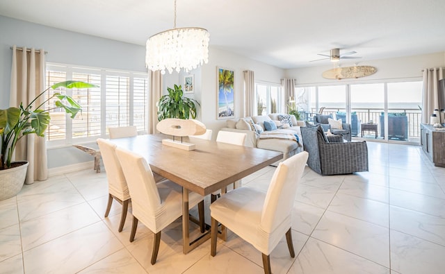 dining room featuring ceiling fan with notable chandelier