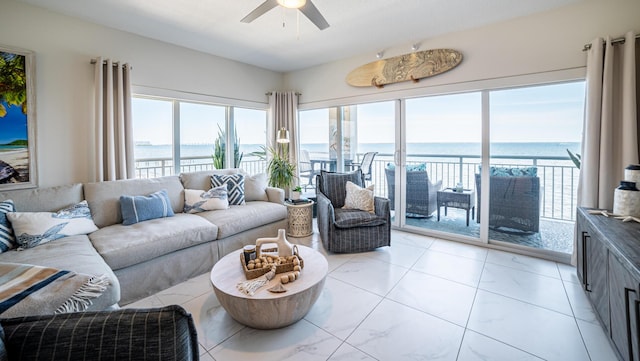 living room featuring a water view and ceiling fan