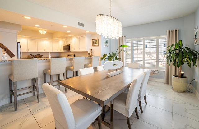 dining space with a chandelier