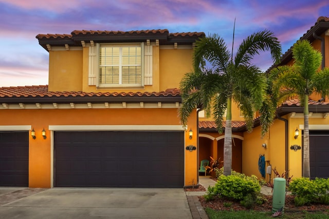 mediterranean / spanish-style home featuring a garage