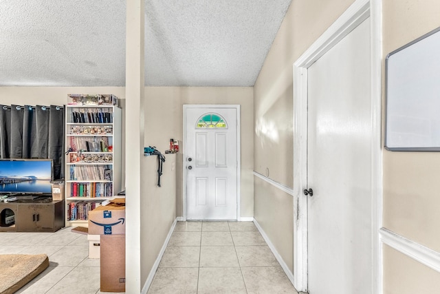 tiled foyer featuring a textured ceiling