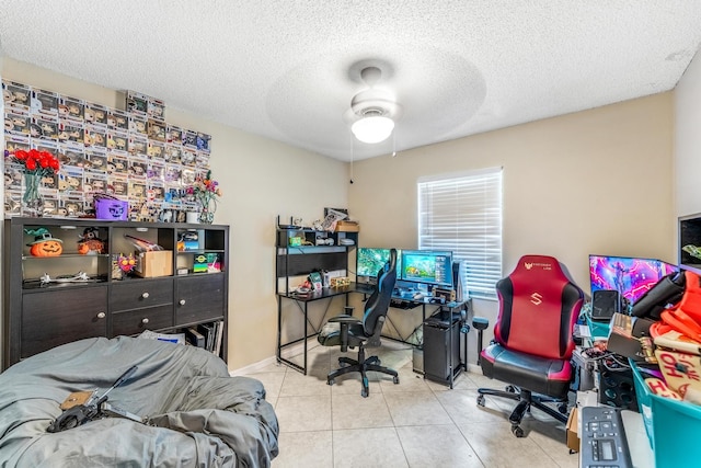 home office featuring a textured ceiling, ceiling fan, and light tile patterned floors