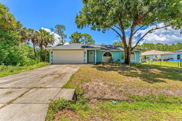 ranch-style home with a garage and a front lawn