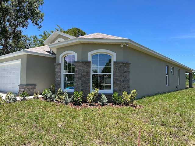 view of property exterior featuring a garage and a lawn