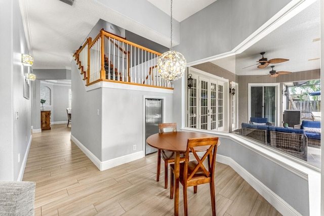 dining room featuring crown molding and ceiling fan with notable chandelier