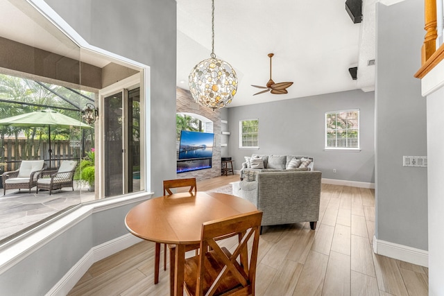 dining space with lofted ceiling, light wood-type flooring, and ceiling fan